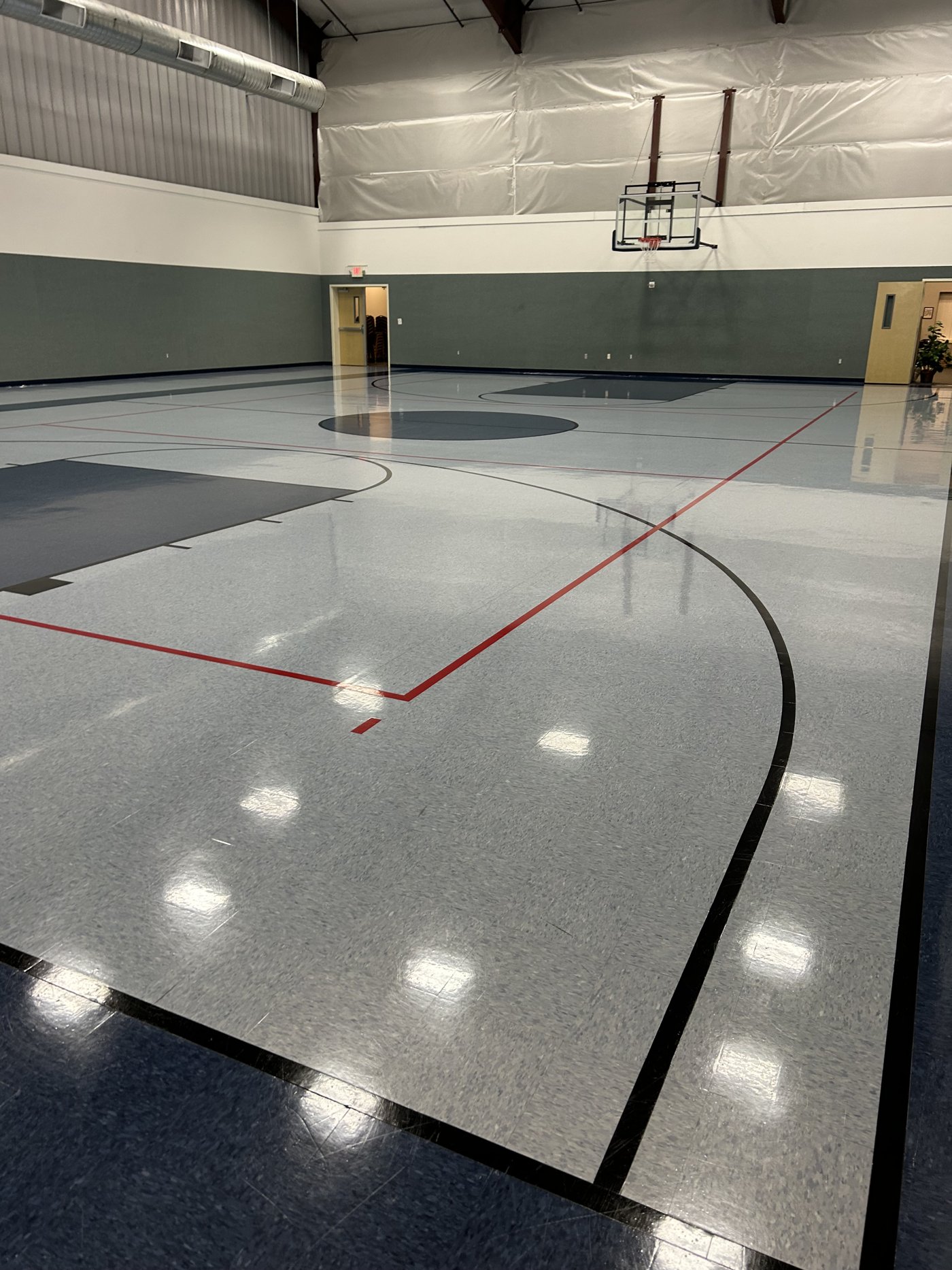 High-gloss multipurpose gymnasium court floor after refinishing