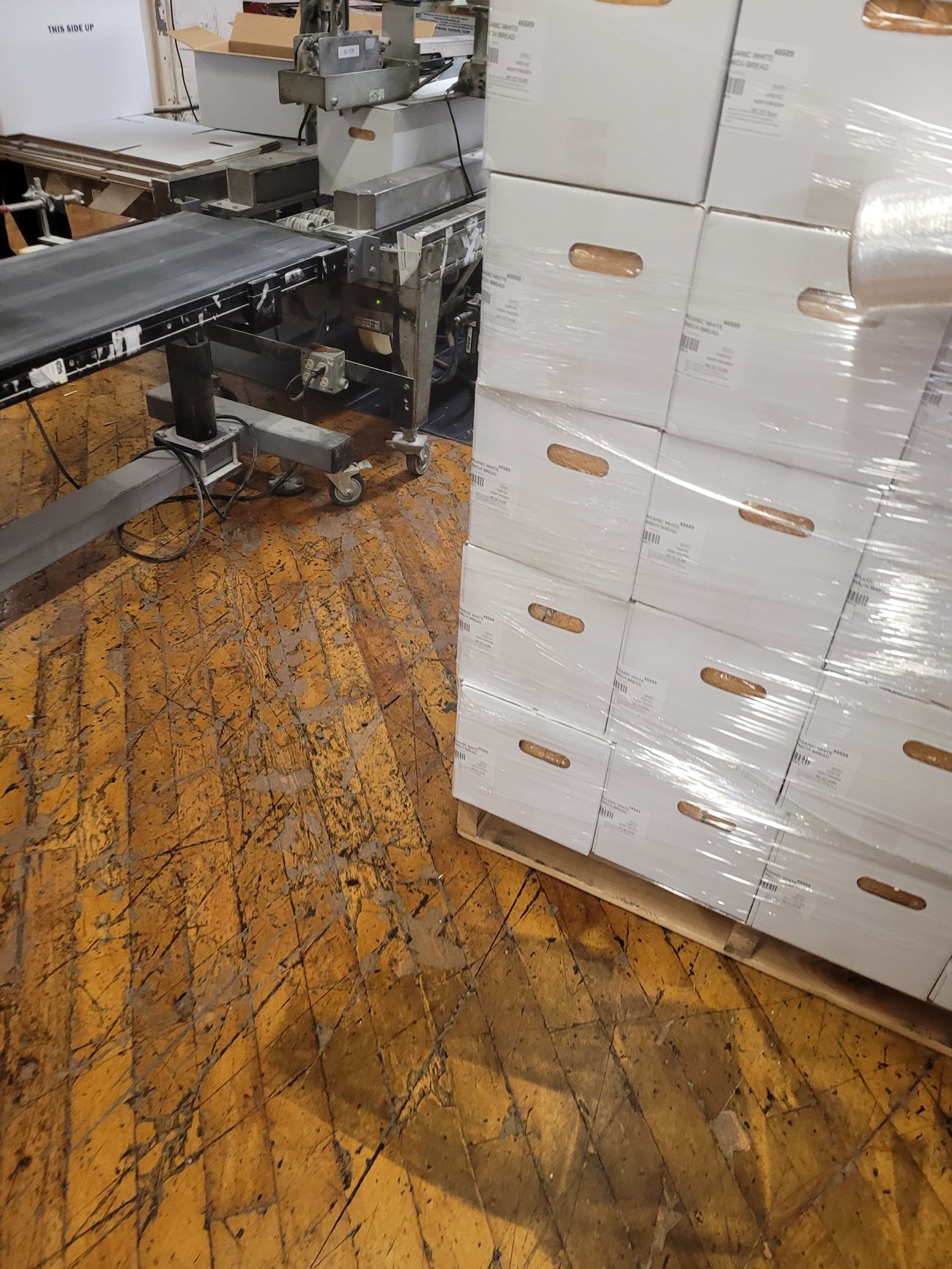 Worn commercial wood floor in a Portland warehouse before refinishing